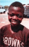 Assane, 10, works as a shoe-shine boy in Senegal