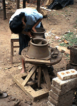 A Sri Lankan potter at work making an Anagi stove